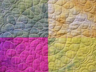 Featured is a macro photo of a section of an Antique Quilt by US photographer Joy Freschly.
